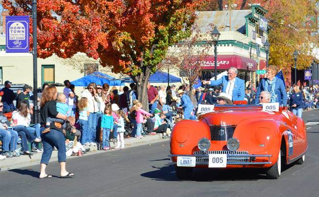 Mike Shaughnessy, the grand marshal of the Nevada Day parade, points as he rides along Carson Avenue on Saturday, Oct. 26, 2013. Shaughnessy was in the first Nevada Day parade 75 years ago as a 3-year-old dressed as Daniel Boone.
